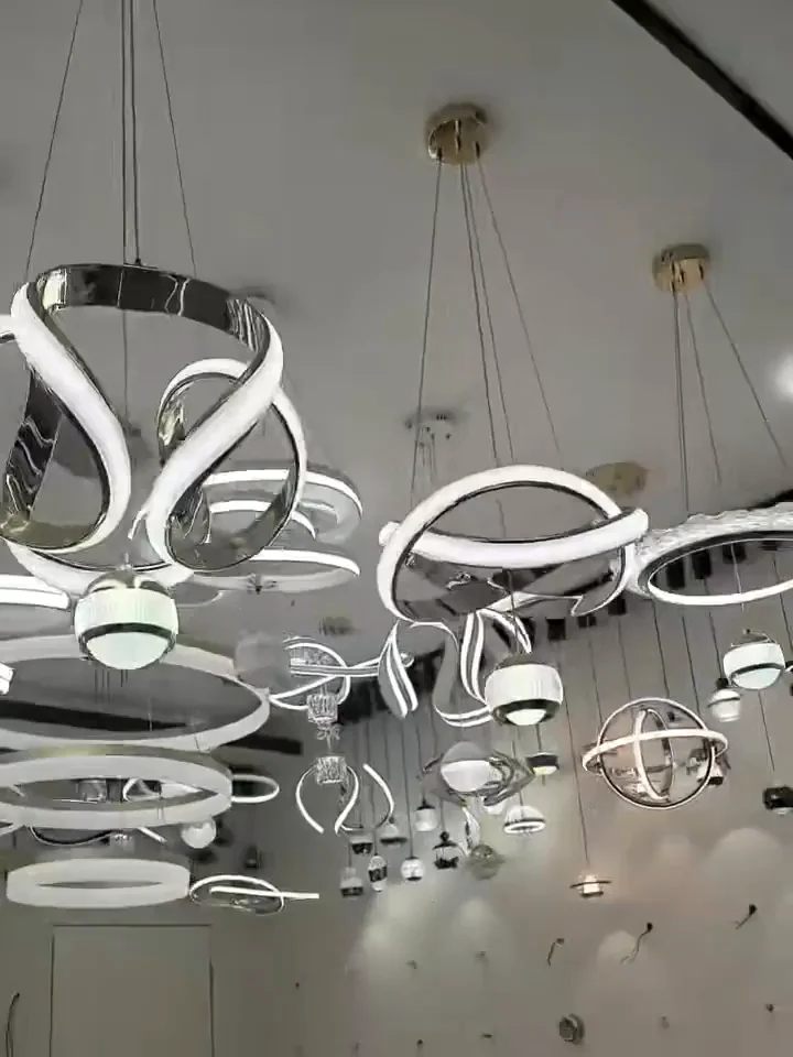 A showroom ceiling hung with rows of white and chrome ring chandeliers